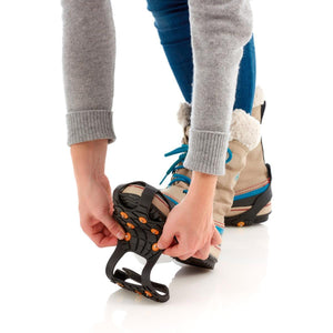 Person attaching Sidas ice grips to winter boots