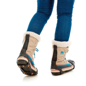 Sidas traction cleats attached to Sorel winter boots worn with blue jeans