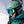 Person wearing a matte green Smith Optics helmet and blue mirrored goggles