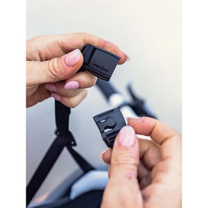 Hands fastening a Smith Optics Fidlock magnetic helmet buckle