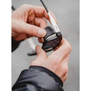 Hands attaching a side shield to Smith sunglasses