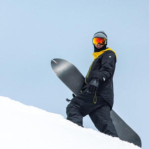 Snowboarder wearing Smith Optics goggles and winter gear standing on a snowy slope