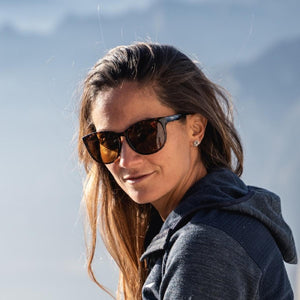 Woman wearing Smith Optics sunglasses with dark frames and tinted lenses