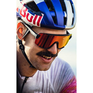 Cyclist wearing Smith Optics sunglasses with orange mirrored lenses and a cycling helmet