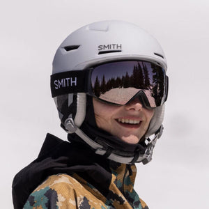 Person wearing a white Smith Optics helmet and mirrored goggles