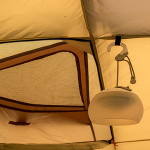 Snow Peak lantern hanging from the ceiling of a tent