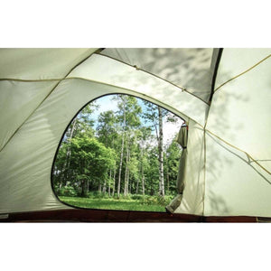 View of a forest through an open tent door