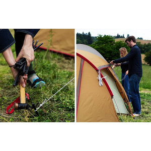 Snow Peak tent being set up with a hammer and stakes in a grassy field