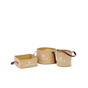 Three tan Snow Peak collapsible storage containers with maroon handles