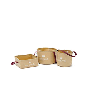 Three tan Snow Peak collapsible storage containers with maroon handles on a white background
