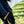 Person wearing black work apron with a hammer tucked into the waist loop