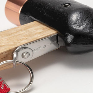 Close up of a hammer head with a wooden handle and a metal tag stamped with Made in Japan