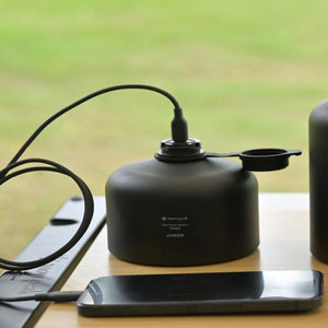 Snow Peak and Anker Giga Power Battery 15000 charging a smartphone on a table