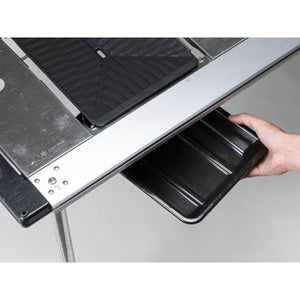 Hand sliding a black tray into a Snow Peak metal camping table