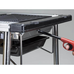 Hand using a red lighter to ignite a Snow Peak camping grill
