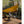 Person cooking at a Snow Peak camping table under a yellow tarp in a forest