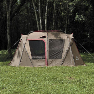 Snow Peak brown camping tent with mesh windows set up on a grassy field in front of trees