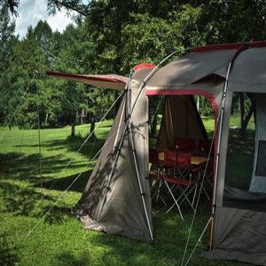 Snow Peak tent with extended canopy and outdoor dining set on a grassy field