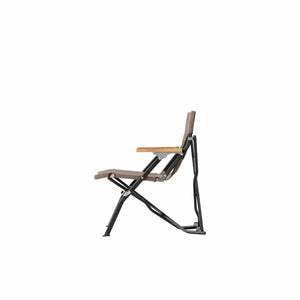 Snow Peak folding camping chair with brown fabric seat and wooden armrests viewed from the side