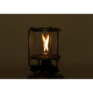Lit glass camping lantern with metal frame