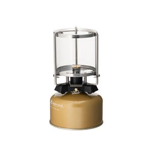 Snow Peak gas lantern with glass globe and metal frame on a gold fuel canister