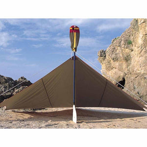 Snow Peak tarp set up on a sandy beach with a paddle as a support pole
