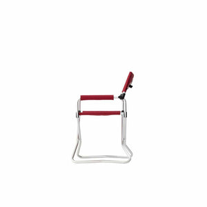 Side view of a red and silver folding beach chair