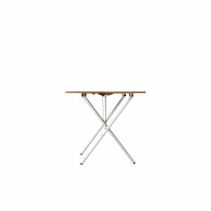 Side view of a folding table with a wooden top and white metal cross legs