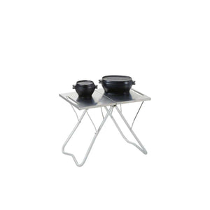 Snow Peak folding metal table with two black cast iron pots on top