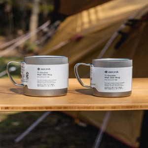 Snow Peak Ti-Double Wall 450 and 300 mugs with product labels on a wooden table