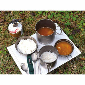 Snow Peak titanium cookware set with rice and soup on a portable camping table
