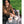 Person using Snow Peak white food containers and stainless steel bottle on a felt mat outdoors