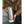Person holding a stainless steel Snow Peak tumbler with a white silicone base