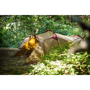 Snow Peak brown tunnel tent set up in a wooded area