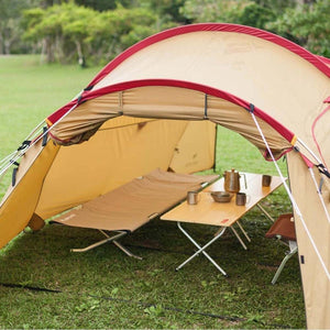 Snow Peak tent with camping cot and table set up on grass