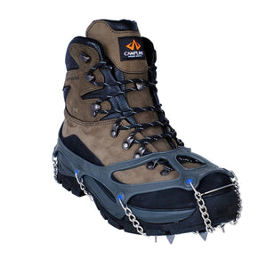 Snowline traction spikes attached to a brown hiking boot