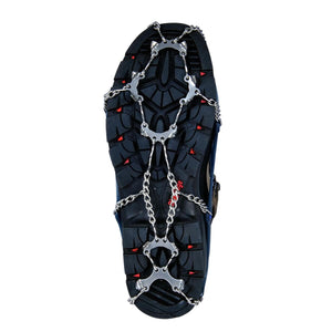 Snowline traction spikes attached to the sole of a hiking boot