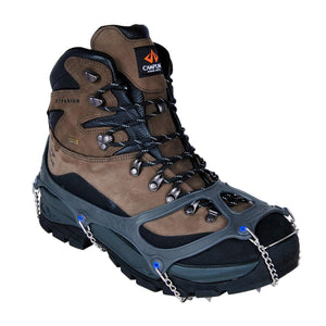 Snowline traction spikes attached to a brown and black hiking boot