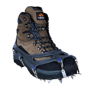 Snowline traction cleats attached to a brown and black hiking boot