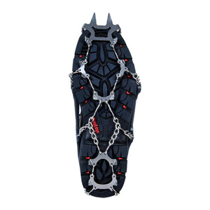 Snowline traction spikes attached to the sole of a black hiking boot