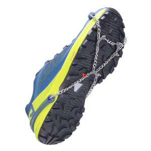 Snowline traction spikes attached to the sole of a blue and yellow trail running shoe