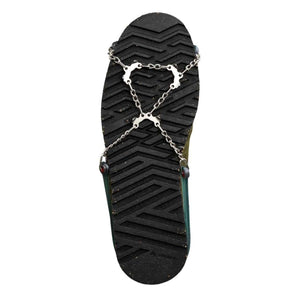 Snowline traction spikes attached to the sole of a hiking boot