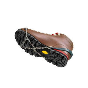 Snowline traction spikes attached to the sole of a brown hiking boot