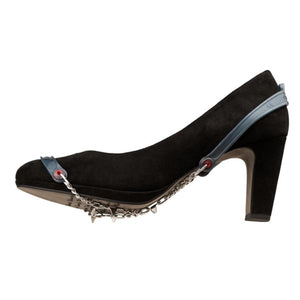 Snowline traction spikes attached to a black high heel shoe