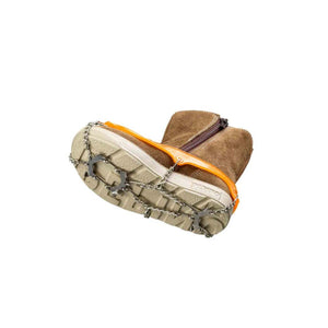 Snowline traction spikes attached to a brown suede boot