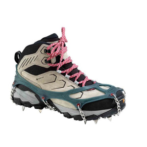 Hiking boot with blue rubber traction spikes and metal chains attached to the sole