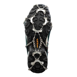 Metal traction spikes attached to the sole of a hiking boot