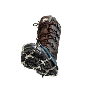 Snowline traction spikes attached to a brown leather hiking boot