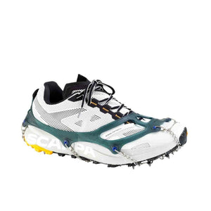 Snowline traction spikes attached to a white Scarpa trail running shoe