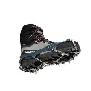 Snowline crampons attached to a grey and black hiking boot